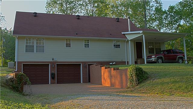 255 Biggs Road Cottontown, TN 37048 - Photo 15 of 18 Your home from the back is attractive as well. Check out the aggregate drive leading into the garage and the additional carport located just outside the kitchen's back door. You will not get wet bringing the groceries in!