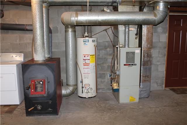 255 Biggs Road Cottontown, TN 37048 - Photo 18 of 18 Don't forget this feature! The heating unit is electric but there is a wood stove that serves as an alternate heat source. The Wood stove is vented into the central duct system.