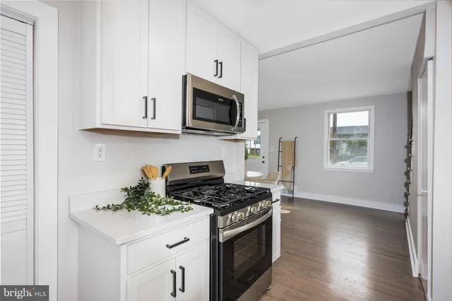 a kitchen with stainless steel appliances granite countertop a stove a microwave and a refrigerator