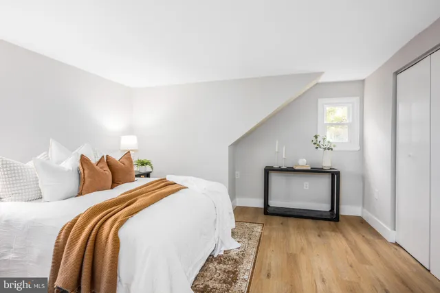 a bedroom with a bed and a fireplace