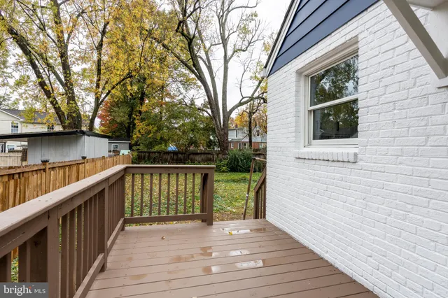 a view of deck with wooden floor and trees