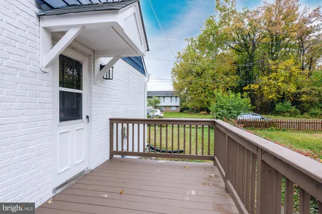 a view of balcony with wooden floor and fence
