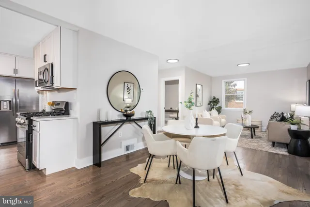 a view of a dining room with furniture and a mirror