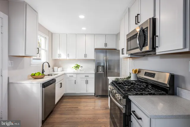 a kitchen with stainless steel appliances granite countertop a stove a sink dishwasher and a refrigerator