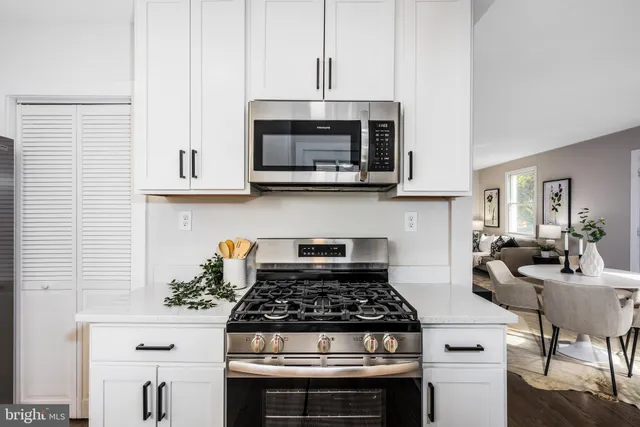a stove top oven sitting inside of a kitchen