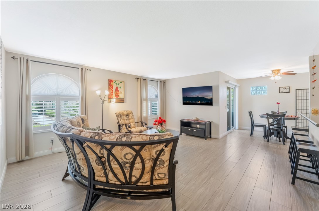 3145 East Flamingo Road, Unit 1092 Las Vegas, NV 89121 - Photo 1 of 33 Ceramic tile flooring extends through this open-concept living area with a ceiling fan and sliding doors.