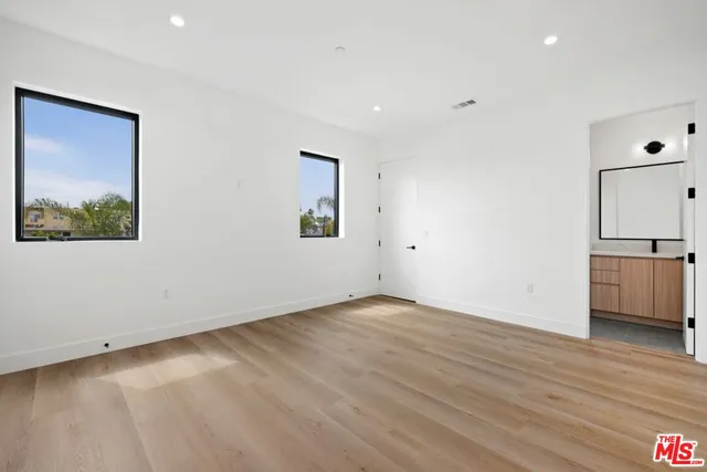 a view of a kitchen with wooden floor and a sink