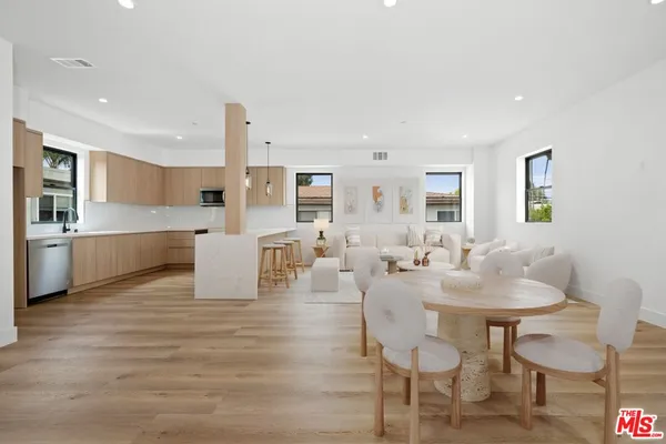 a living room with furniture and kitchen view
