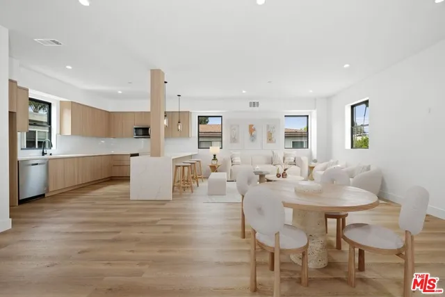 a living room with furniture and kitchen view