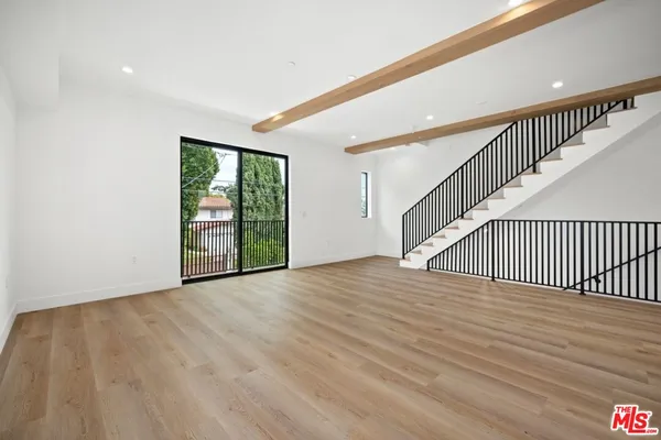 a view of an entryway with wooden floor