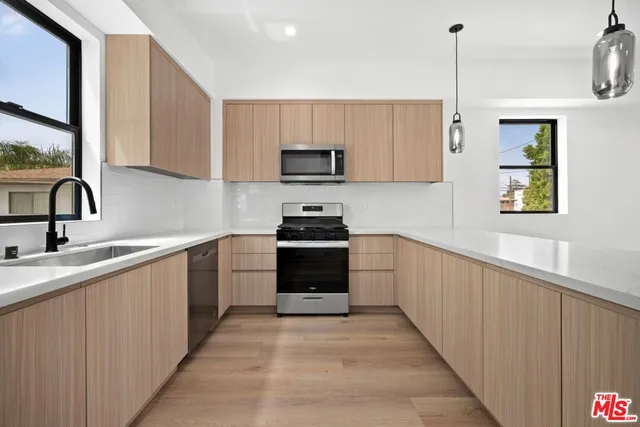 a kitchen with a sink and appliances