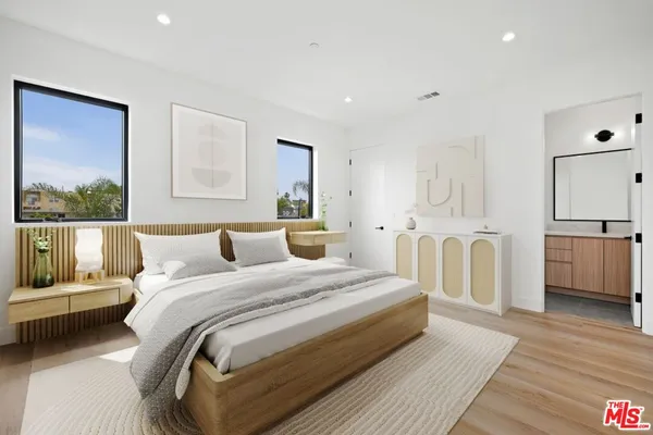 a bedroom with a bed and a view of kitchen