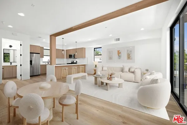 a living room with furniture kitchen and a table