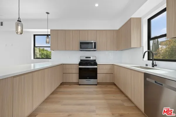 a kitchen with a sink cabinets and window