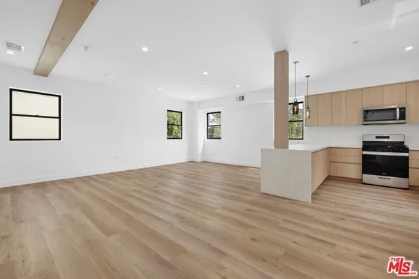 a view of a kitchen with microwave and cabinets