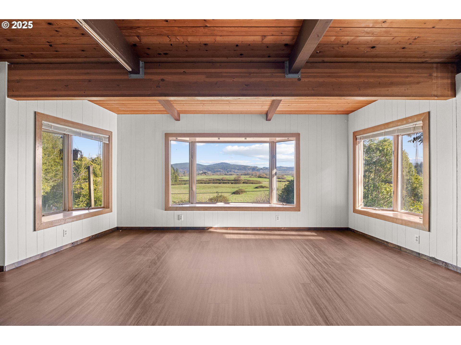 53874 Fishtrap Road Myrtle Point, OR 97458 - Photo 12 of 48 a view of an empty room with wooden floor and a window