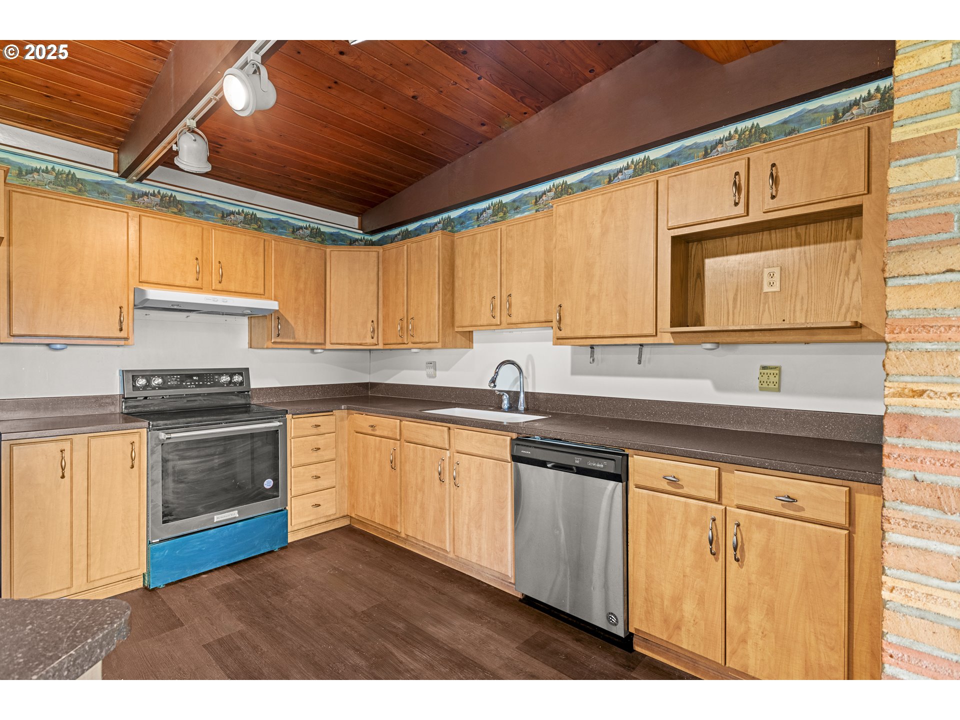 53874 Fishtrap Road Myrtle Point, OR 97458 - Photo 14 of 48 a kitchen with stainless steel appliances granite countertop a sink a stove cabinets counter space and a window