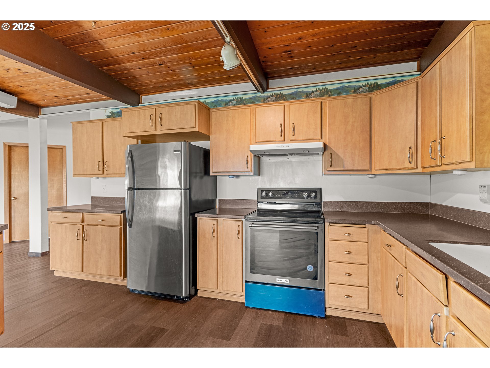53874 Fishtrap Road Myrtle Point, OR 97458 - Photo 15 of 48 a kitchen with appliances cabinets and a wooden floor