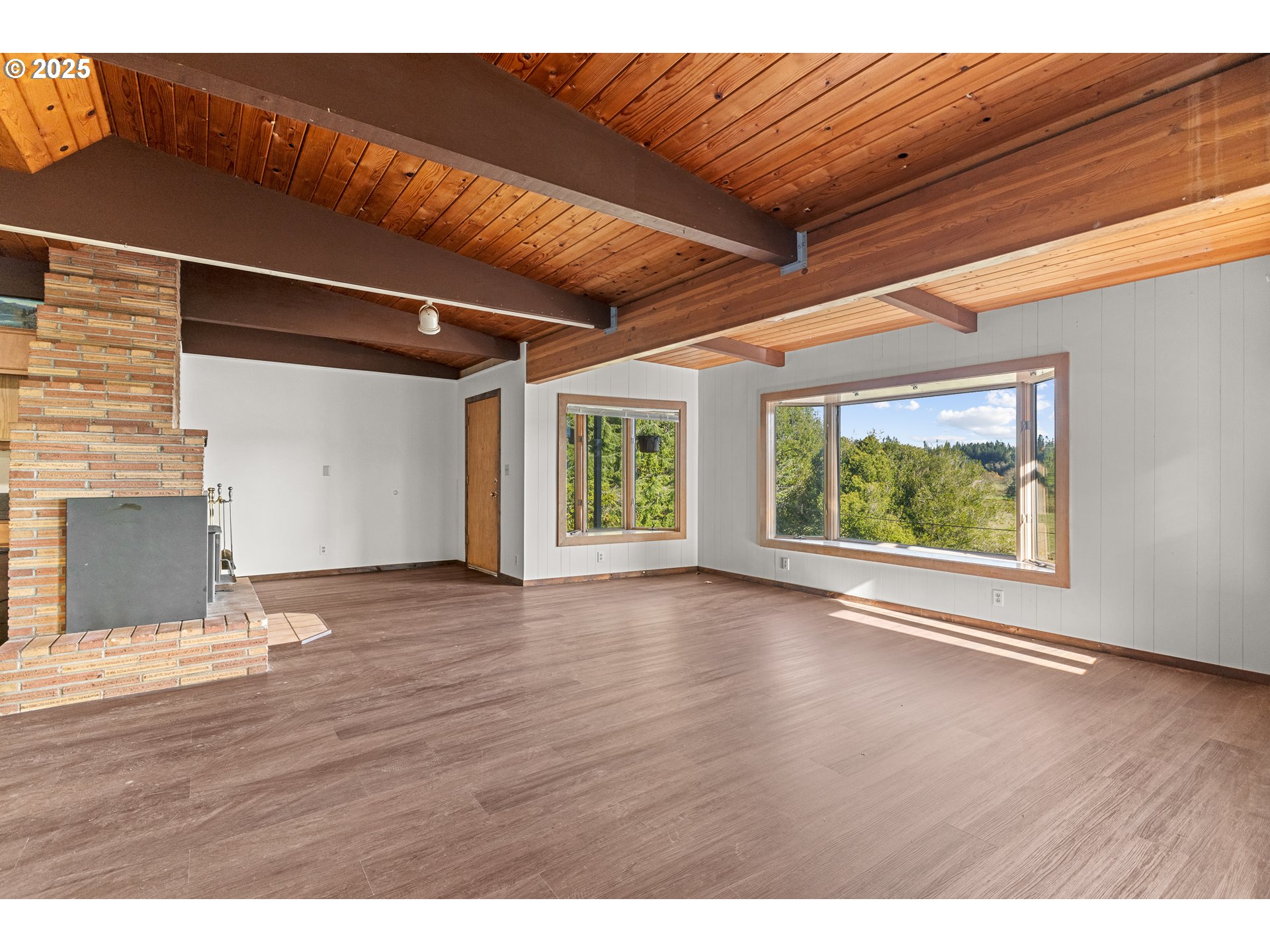 53874 Fishtrap Road Myrtle Point, OR 97458 - Photo 19 of 48 a view of an empty room with wooden floor and a window