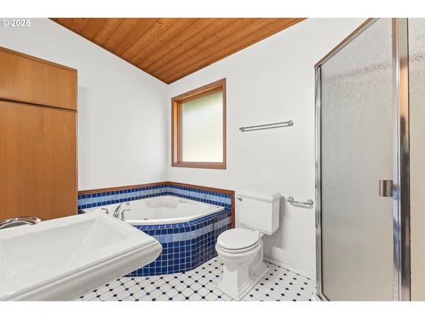 a view of an empty room with closet and a window