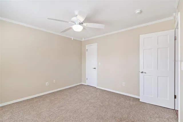 a view of an empty room with a fan