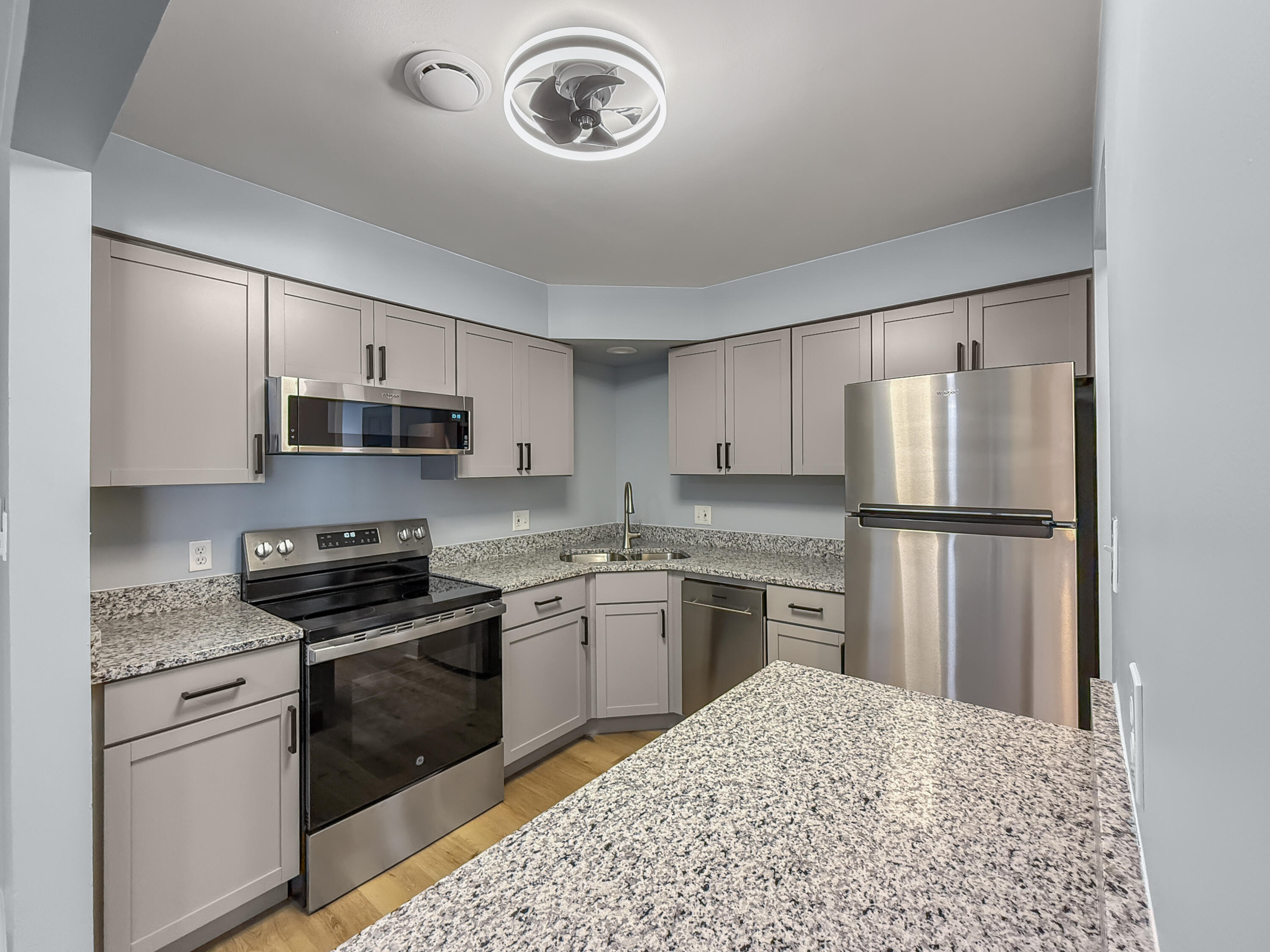 2049 45th Street, Unit 101 Highland, IN 46322 - Photo 3 of 13 a kitchen with stainless steel appliances granite countertop a refrigerator stove top oven and sink