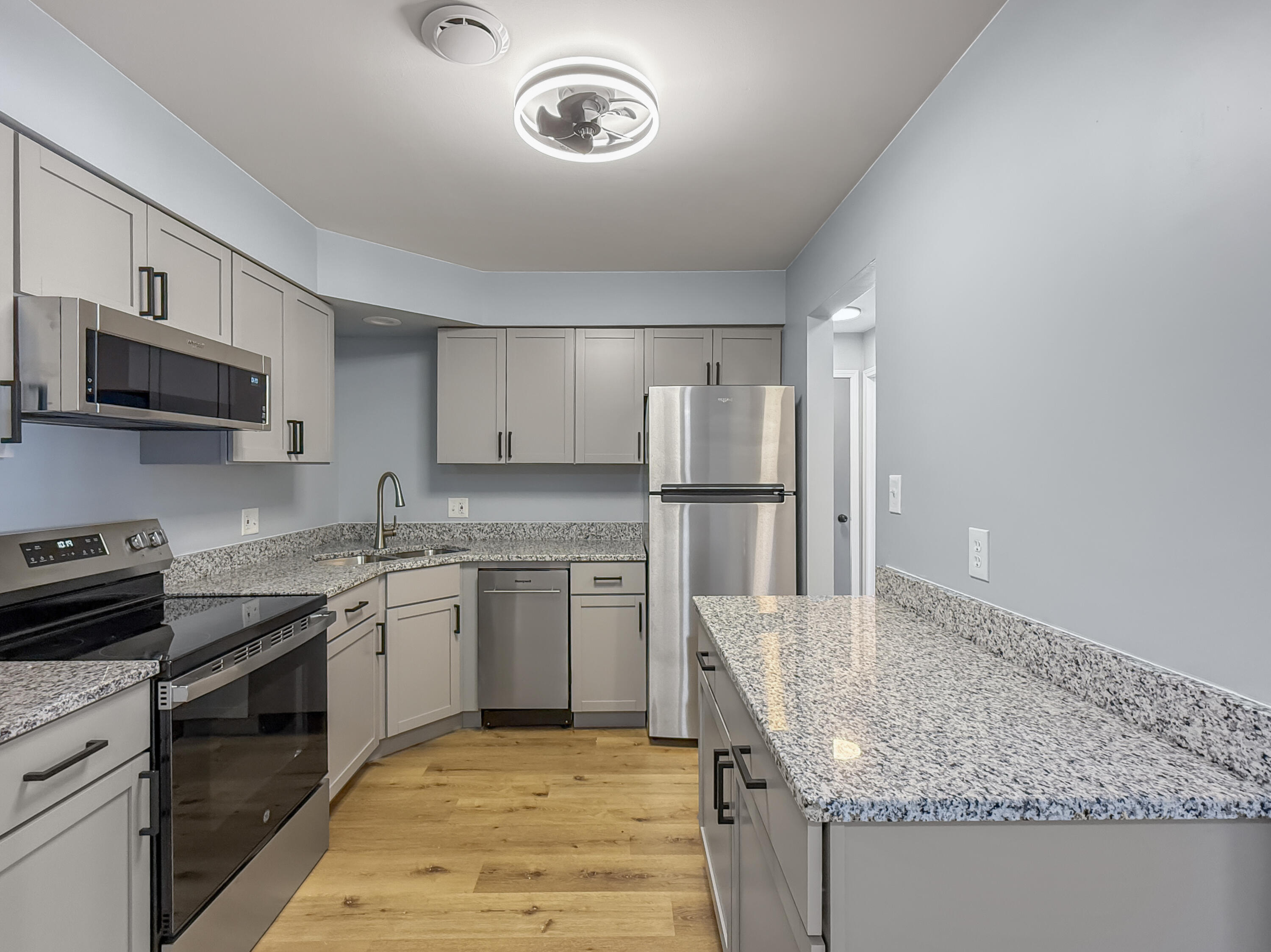 2049 45th Street, Unit 101 Highland, IN 46322 - Photo 4 of 13 a kitchen with stainless steel appliances granite countertop a sink stove and refrigerator