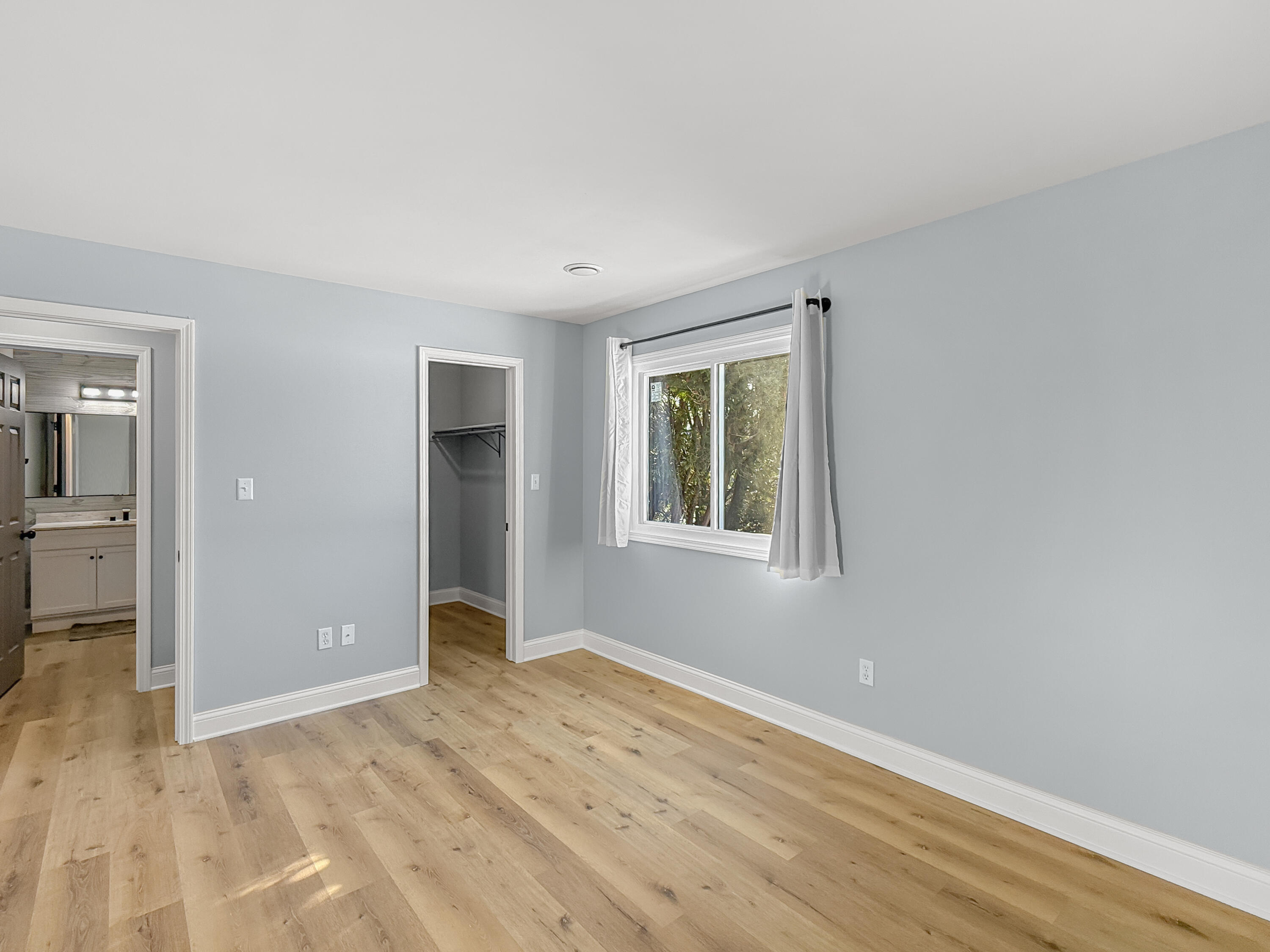 2049 45th Street, Unit 101 Highland, IN 46322 - Photo 5 of 13 a view of an empty room with wooden floor and a window