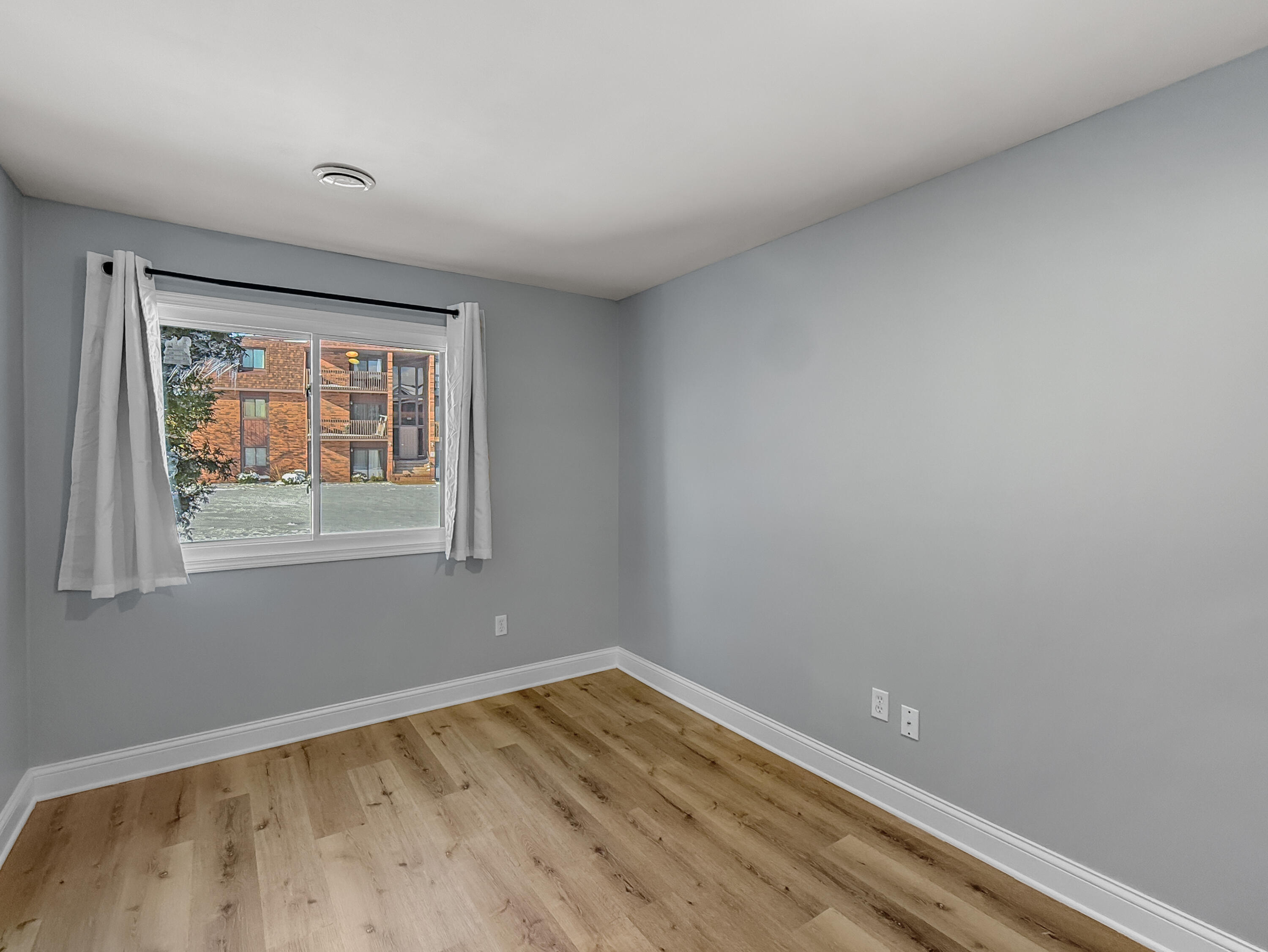 2049 45th Street, Unit 101 Highland, IN 46322 - Photo 7 of 13 a view of empty room with wooden floor and fan