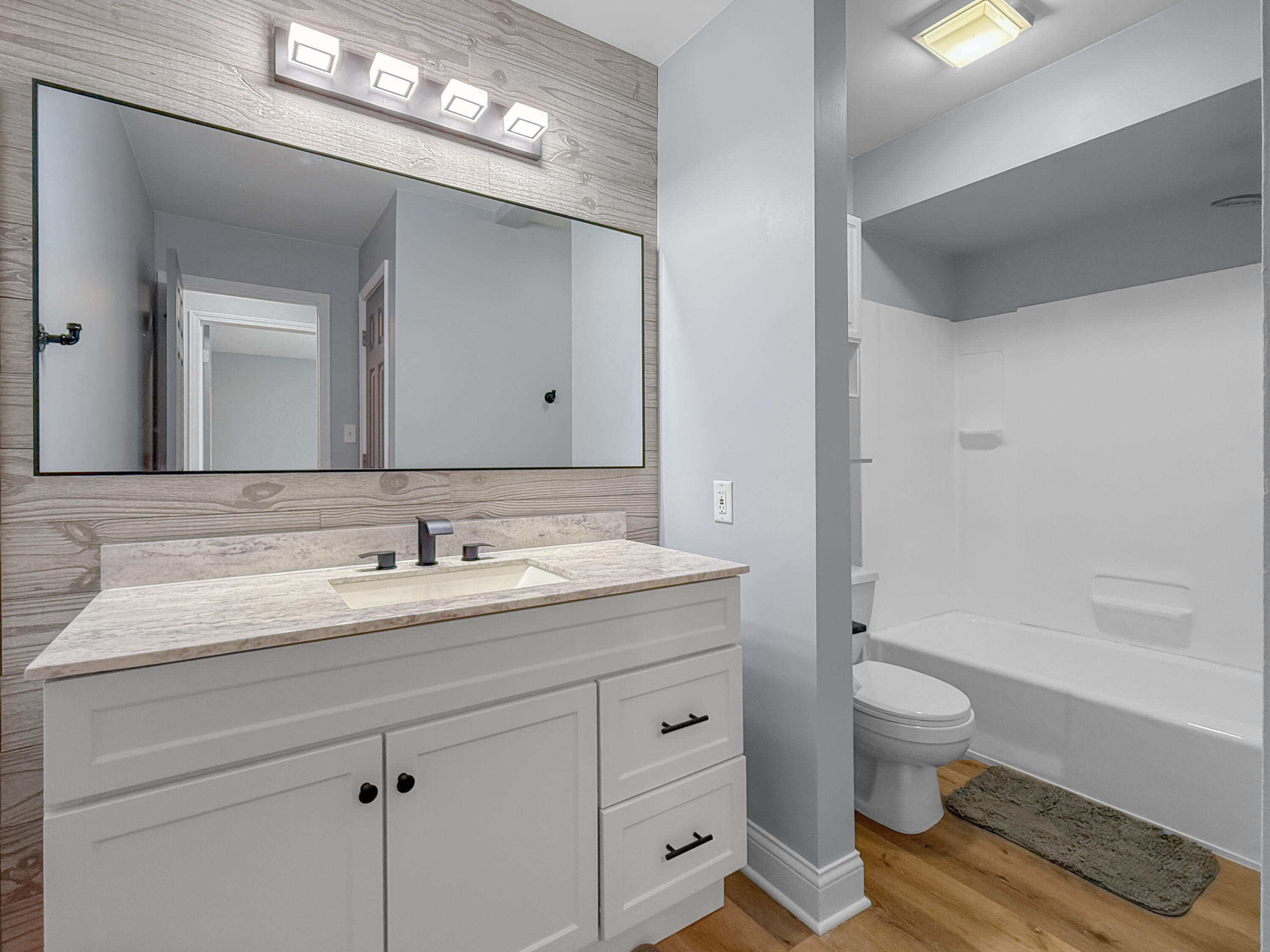 2049 45th Street, Unit 101 Highland, IN 46322 - Photo 9 of 13 a bathroom with a sink a toilet and a large mirror