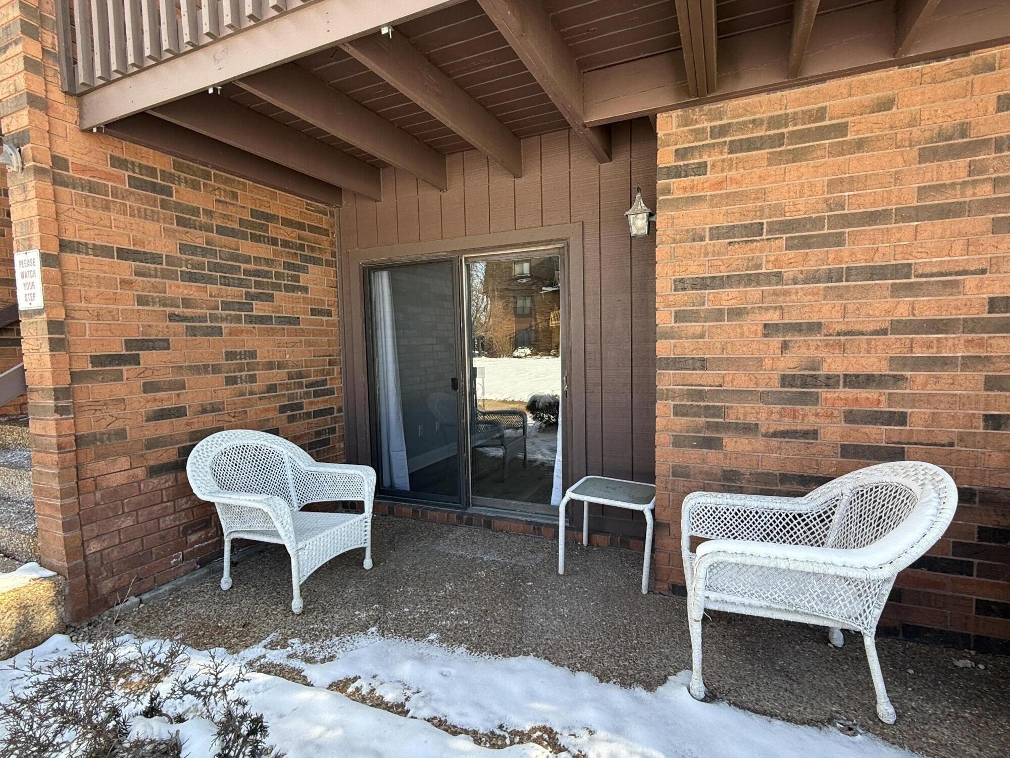 2049 45th Street, Unit 101 Highland, IN 46322 - Photo 10 of 13 a balcony with a couch and a potted plant