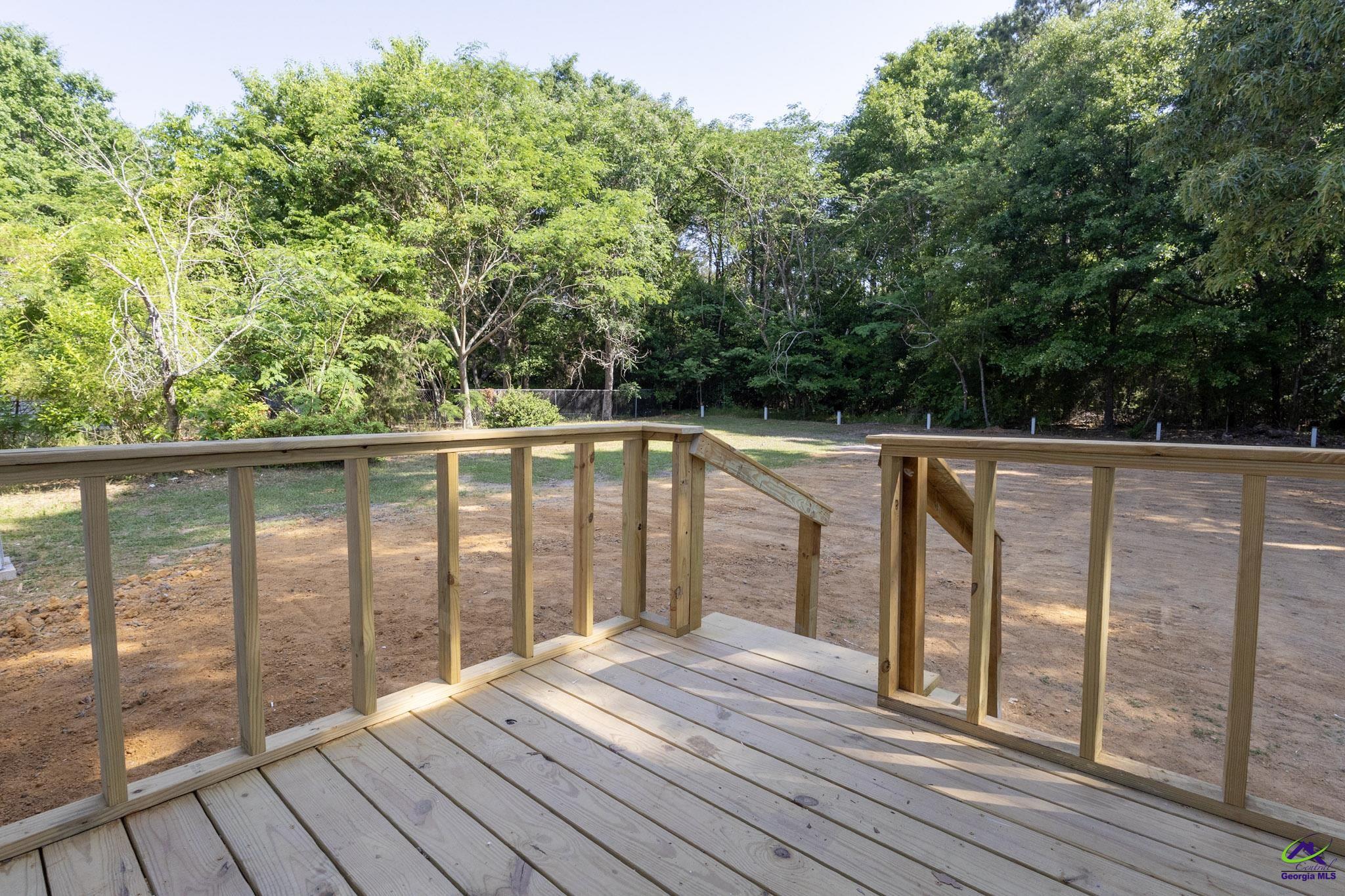 156 Churchwell Road Cochran, GA 31014 - Photo 19 of 20 a view of roof deck with wooden floor and fence