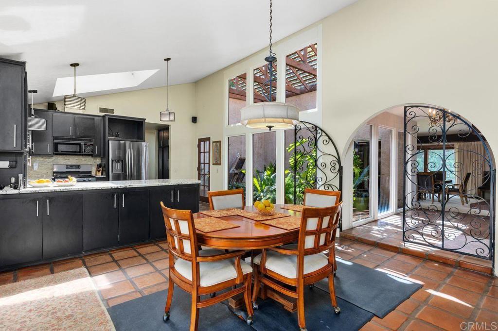 29560 Lilac Road Valley Center, CA 92082 - Photo 9 of 43 a dining room with furniture and a floor to ceiling window