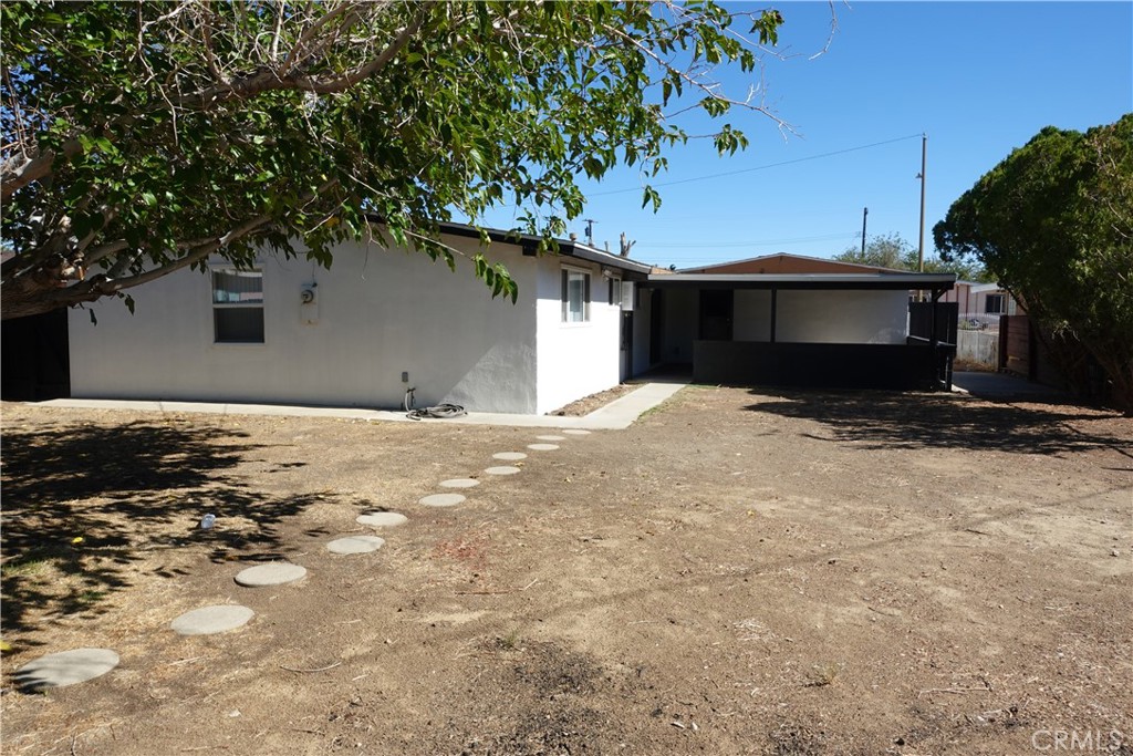 38467 36th Street East Palmdale, CA 93550 - Photo 17 of 18 a backyard of a house with large trees and a barn