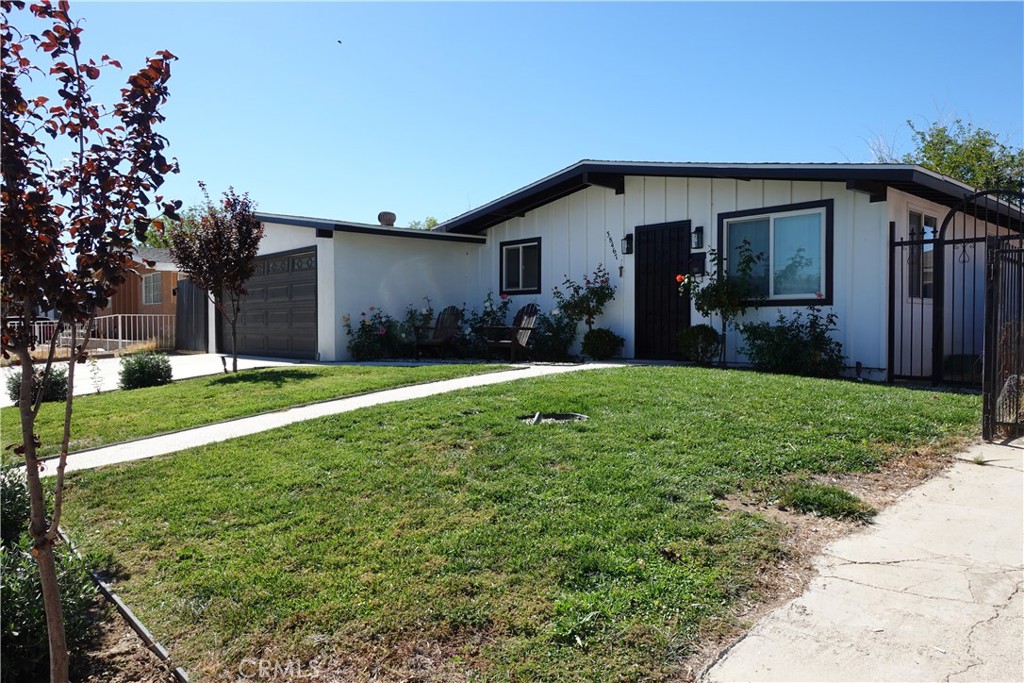 38467 36th Street East Palmdale, CA 93550 - Photo 2 of 18 a view of a house with yard and tree s