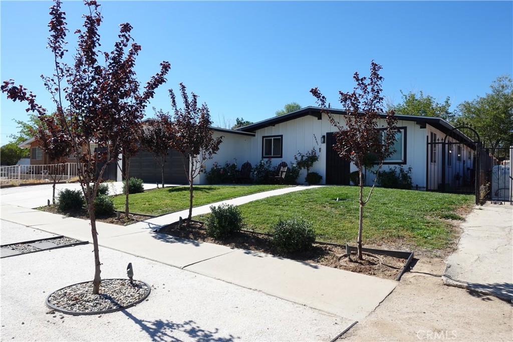 38467 36th Street East Palmdale, CA 93550 - Photo 3 of 18 a front view of a house with garden