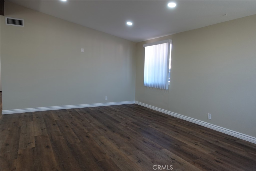38467 36th Street East Palmdale, CA 93550 - Photo 4 of 18 an empty room with wooden floor and windows
