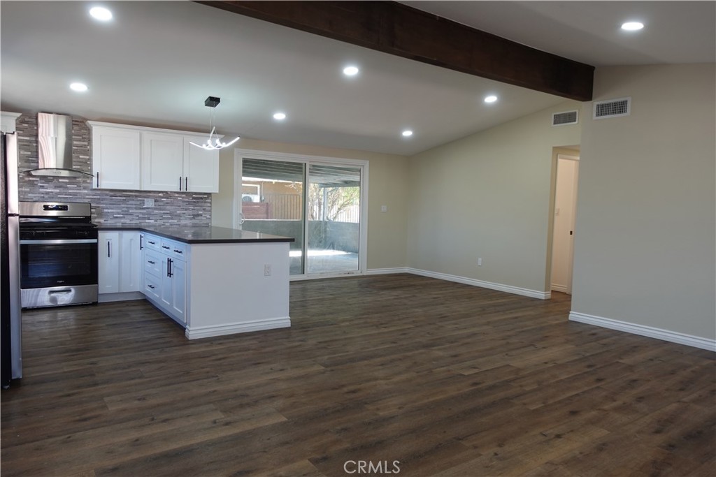 38467 36th Street East Palmdale, CA 93550 - Photo 5 of 18 a large kitchen with stainless steel appliances granite countertop a large stove a large island in the center