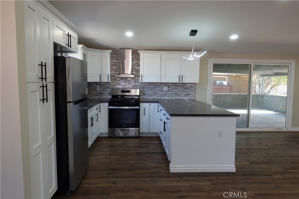 38467 36th Street East Palmdale, CA 93550 - Photo 7 of 18 a kitchen with stainless steel appliances granite countertop a sink a stove and refrigerator