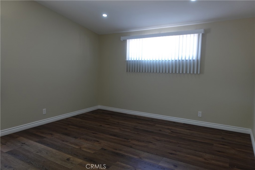 38467 36th Street East Palmdale, CA 93550 - Photo 9 of 18 an empty room with wooden floor and windows
