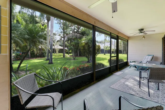 a view of a porch with furniture and garden