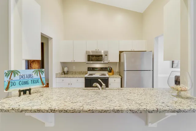 a kitchen with a refrigerator sink and a stove