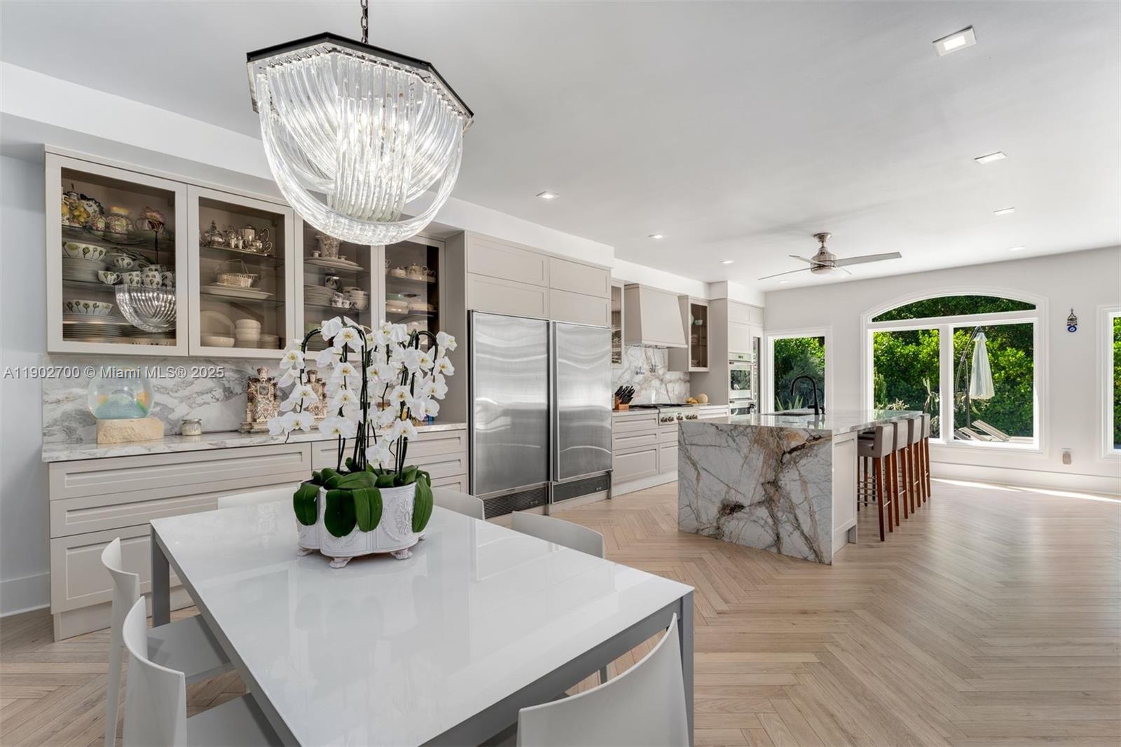 5770 Southwest 100th Street Pinecrest, FL 33156 - Photo 13 of 57 a view of a dining room with furniture wooden floor and chandelier