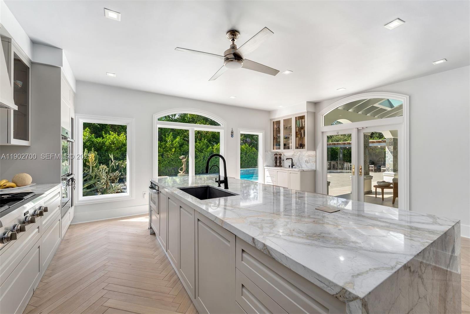 5770 Southwest 100th Street Pinecrest, FL 33156 - Photo 15 of 57 a large kitchen with granite countertop a large window and a sink