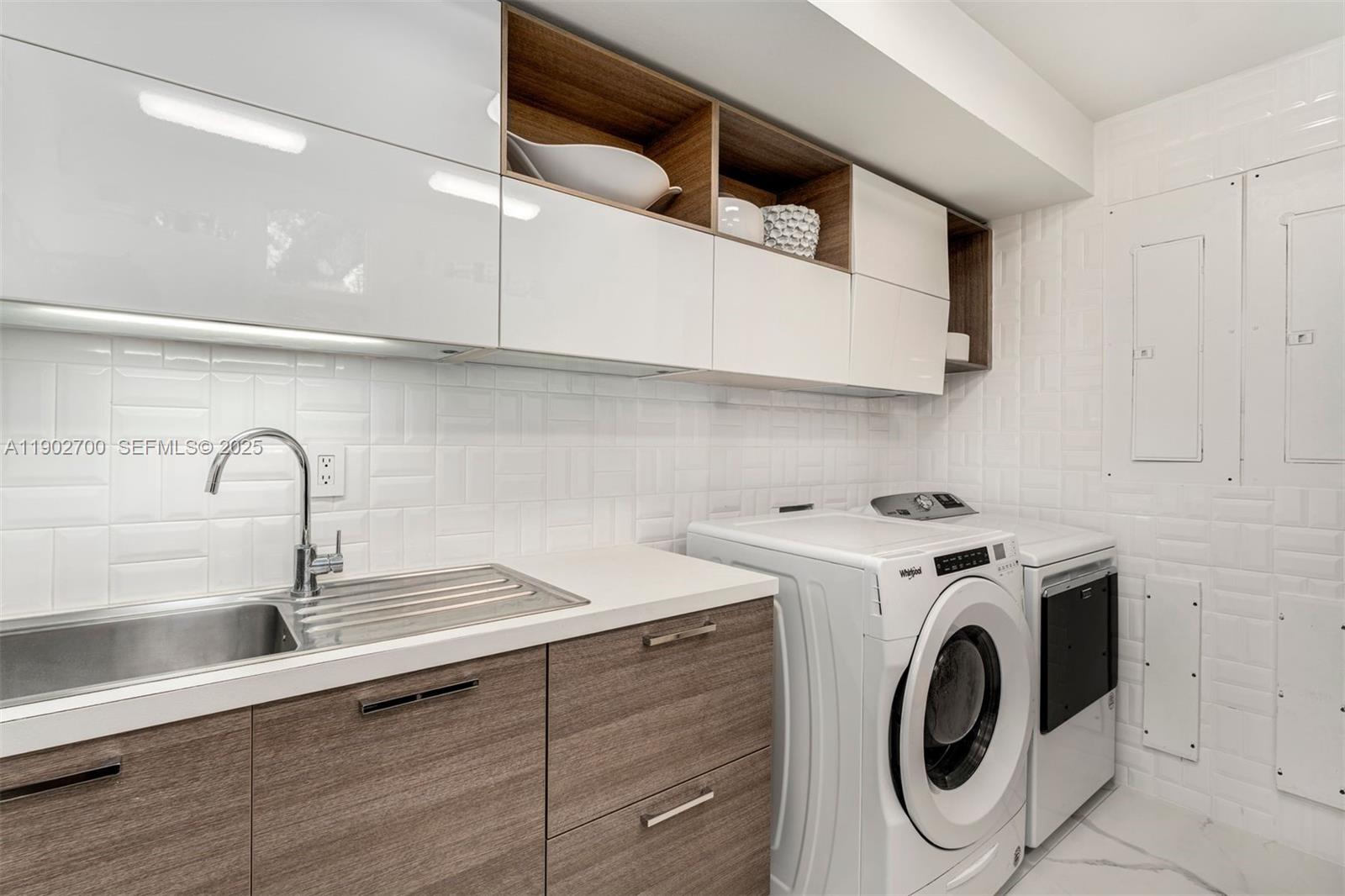 5770 Southwest 100th Street Pinecrest, FL 33156 - Photo 22 of 57 a view of kitchen sink and washer dryer