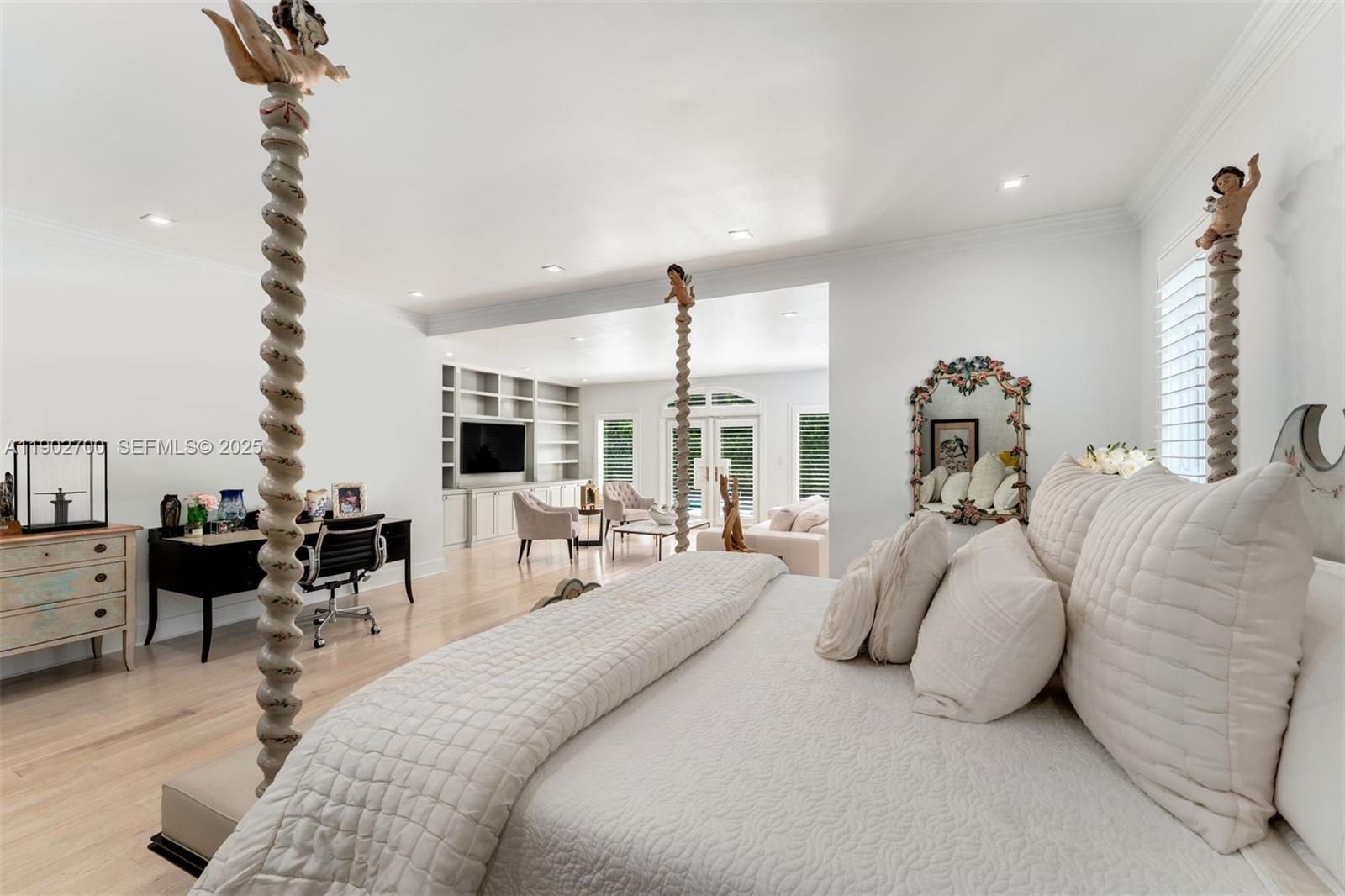 5770 Southwest 100th Street Pinecrest, FL 33156 - Photo 24 of 57 a bedroom with bed and large windows