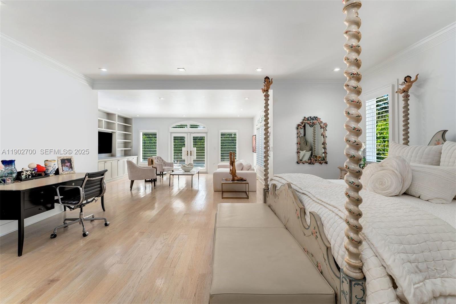 5770 Southwest 100th Street Pinecrest, FL 33156 - Photo 25 of 57 a living room with furniture kitchen view and a wooden floor