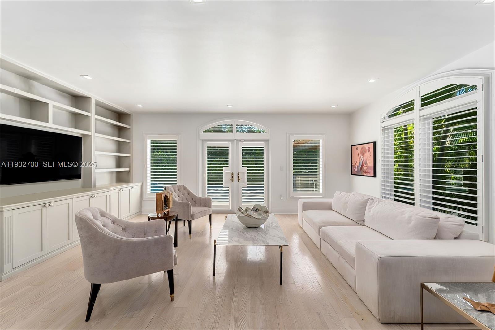 5770 Southwest 100th Street Pinecrest, FL 33156 - Photo 26 of 57 a living room with furniture a flat screen tv and windows