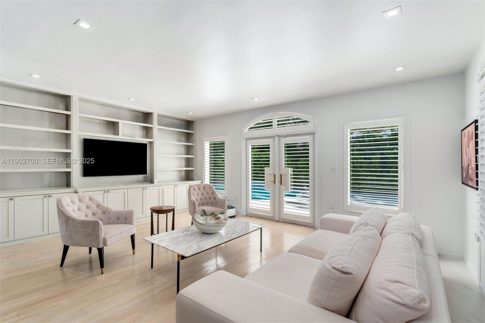 5770 Southwest 100th Street Pinecrest, FL 33156 - Photo 27 of 57 a living room with furniture and a flat screen tv