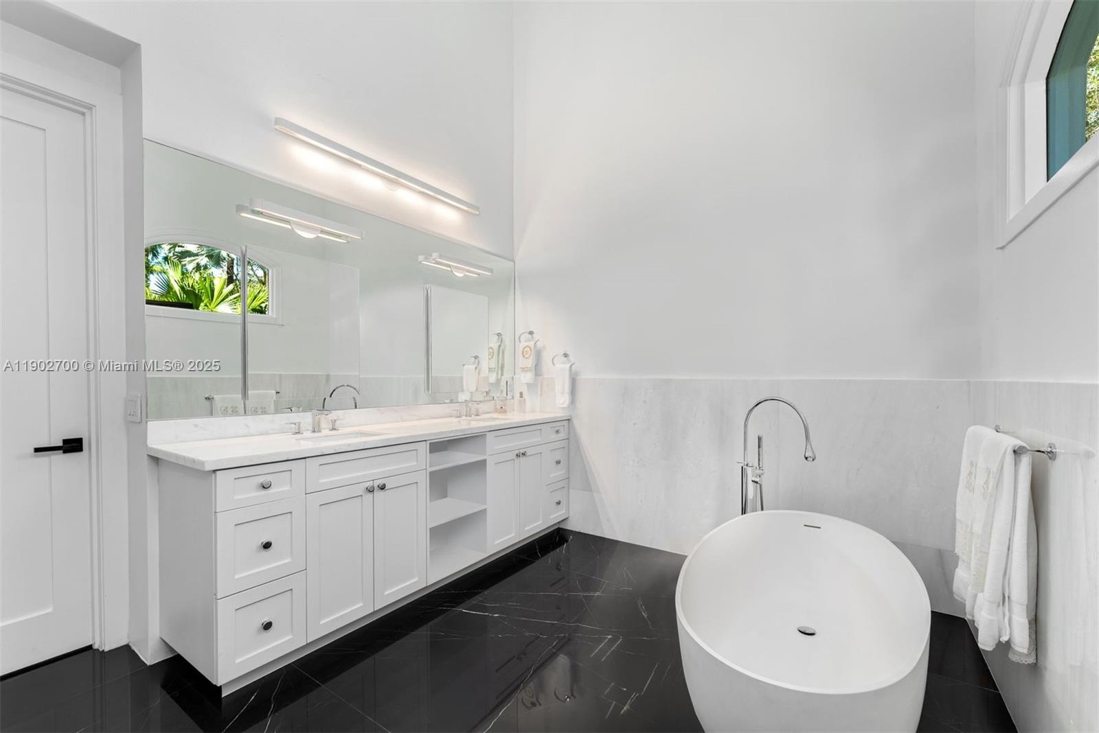 5770 Southwest 100th Street Pinecrest, FL 33156 - Photo 28 of 57 a bathroom with a double vanity sink and a mirror